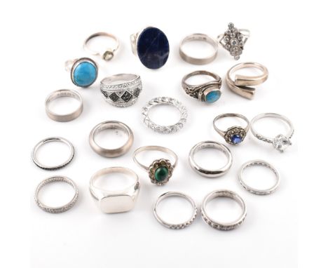 A collection of silver rings. The rings to include band rings, marcasite set dome ring, blue and green cabochon gem set rings