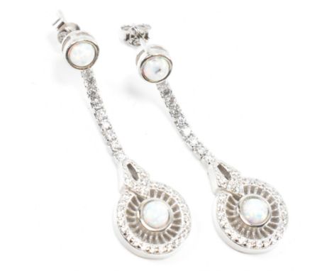 A pair of silver, CZ and synthetic opal pendant earrings. Marked 925 to butterfly back fastener.&nbsp;Measures 3.8cm x 1.2cm.