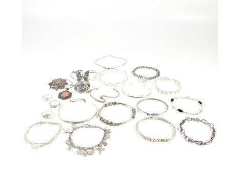 An assorted collection of silver and gem set jewellery. The lot to to include bangles, bracelets, gem set rings, necklace pen