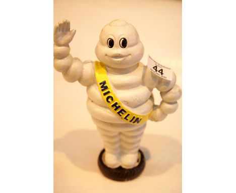 Cast iron Michelin Man waving on tyre moneybox, H: 22 cm. P&amp;P Group 2 (£18+VAT for the first lot and £2+VAT for subsequen