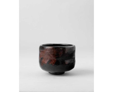 A JAPANESE BLACK RAKU CHAWAN (TEA BOWL)EDO PERIOD, 18TH-19TH CENTURYThe U-shaped bowl raised on a short circular foot, the su