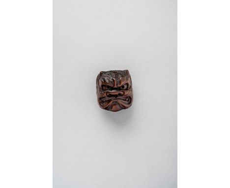 NO RESERVEA JAPANESE WOOD MASK NETSUKE OF AN ONI EDO/MEIJI PERIOD, 19TH CENTURY  The reverse with a small carving of Okame, s