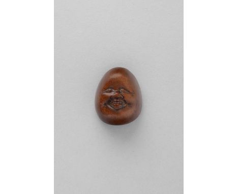 NO RESERVEA JAPANESE WOOD MASK NETSUKE OF OTAFUKU EDO/MEIJI, 19TH CENTURY  Depicted with a chubby smiling face and dimpled op