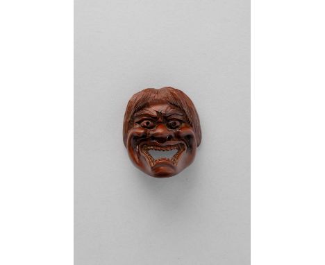 NO RESERVEA JAPANESE WOOD MASK NETSUKE EDO/MEIJI, 19TH CENTURY  Depicting a grimacing face below a thatch of thick hair, sign