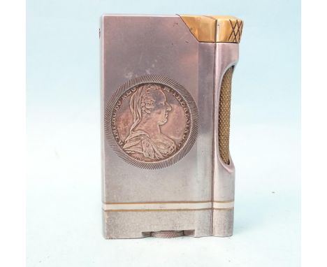 An unusual trench art-style aluminium and brass table lighter inset on each side a Marie Therese thaler, 10.5cm high. 