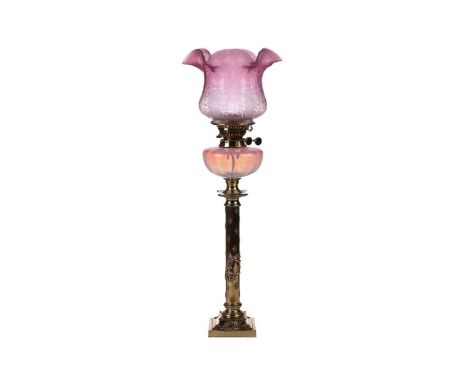 A Victorian brass oil lamp with vaseline and cranberry glass reservoir and diffuser (now fitted for electricity) 72 cm overal