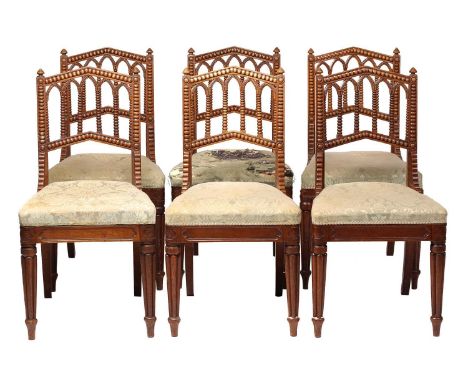 A matched set of six William IV oak Gothic revival side chairs possibly by Gillows of Lancaster the shallow lancet arched bac