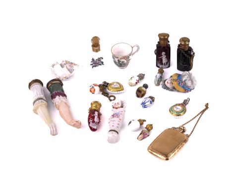 A collection of miniature porcelain and glass scent bottles and containers, including two modelled as human arms, others in c