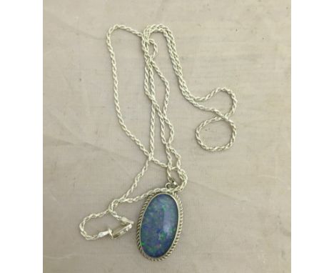 A silver necklace with large black opal doublet pendant