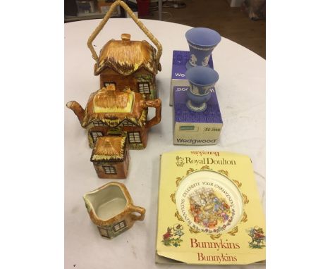 A three-piece tea- service modelled as a cottage, an unusual biscuit barrel/box modelled as a cottage, two Wedgwood vases/urn