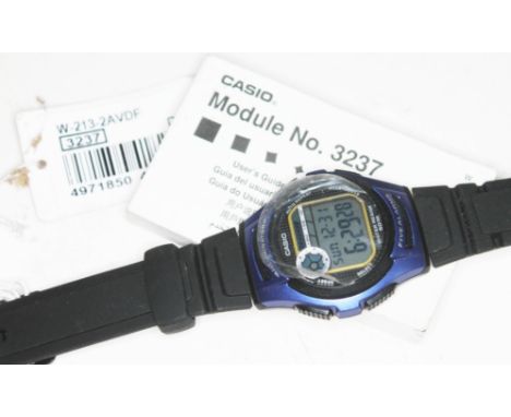 A Casio 3237 digital wristwatch with rubber strap and original user manual.  