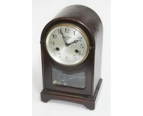 An early 20th century domed top mantle clock, the silver dial signed 'John Collie Oban', height 29cm.  