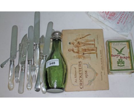 A mixed lot comprising a green glass bottle with hallmarked silver top, a hallmarked silver jam knife, mother of pearl handle