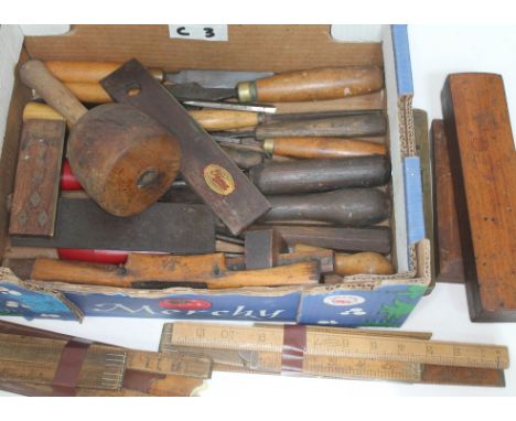A box of vintage wooden hand tools including rulers, mallet, chisels, scribers, whetstones etc  