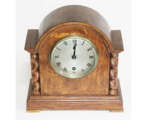 An oak mantle clock with steel dial, height 23.5cm.  