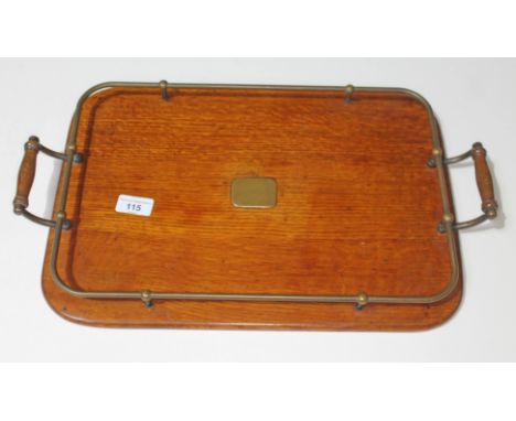 An oak drinks serving tray with brass rail surround and inlaid brass centre  