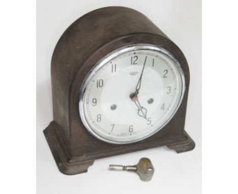 An early 20th century Smiths domed top bakelite mantle clock with silvered dial and Smiths key, height 20cm.  