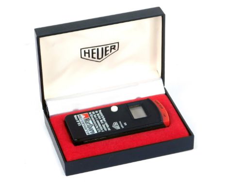 A Heuer electronic lap timer, in box, from the Marlborough World Championship Team, electronic, boxed, a Fiat car badge an Ar