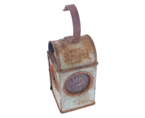 A Sentinel roadworks lantern, in metal casing with red mottled panes.