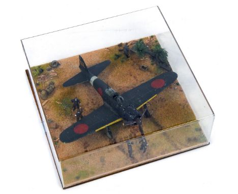 A 1:32 scale cased diorama model of a Mitsubishi Zero AGM, Pacific War, 14cm high, 36cm wide, 36cm deep. 