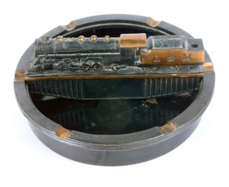 A Litchfield and Madison Railway tin and cast iron ashtray, modelled with an L &amp; M locomotive, 23cm diameter.