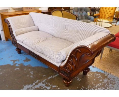 SOFA, early 19th century with a mahogany carved showframe and ticking upholstery, 225cm W x 65cm D x 91cm H. 
