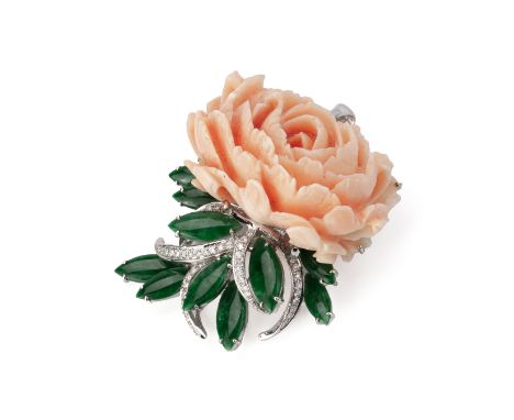 A CARVED CORAL AND JADE BROOCH The large pink coral section finely carved as a flowerhead, in a white gold setting set with r
