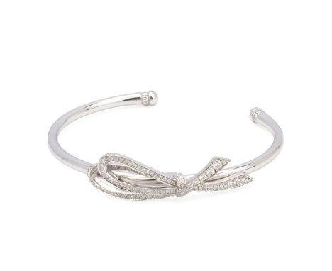 A TIFFANY &amp; CO DIAMOND SET CUFF BANGLE
In white gold the bow design to the front set with round brilliant cut diamonds, s