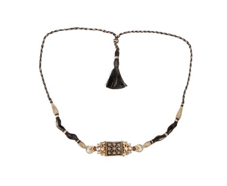 AN INDIAN GOLD AND ENAMEL PENDANT NECKLACE
Square with foliate hinged sides, one side set with naively cut white stones withi