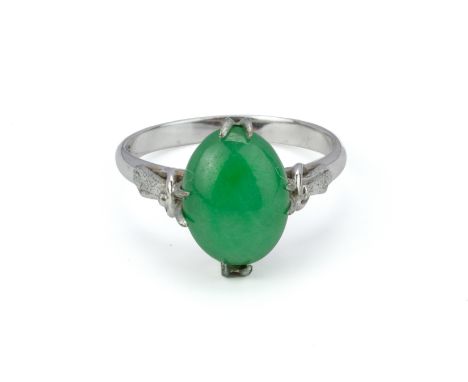 A JADE CABOCHON RING
To be sold at no reserve
The oval jade cabochon in decorative claw setting, in white gold mount marked '