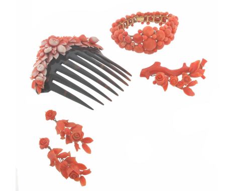 A suite of coral jewellery, comprising a tortoiseshell hair comb surmounted with foliate carved coral sections, 8.8cm wide. A