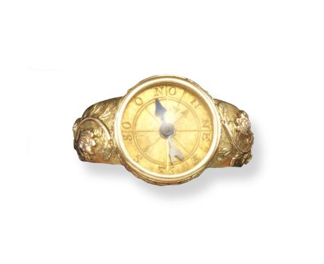 An early 19th century gentleman's gold compass ring, mounted within laurel border and tri-colour gold foliate shoulders. With