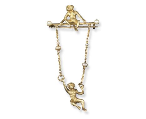 A pearl-mounted gold monkey brooch, one monkey is sitting on a gold bar with seed pearl terminals, and supporting a further m