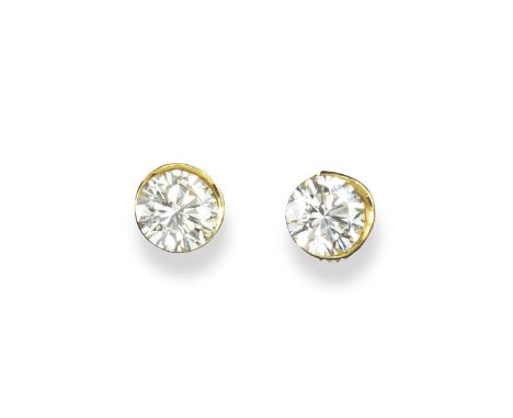 A pair of diamond stud earrings, the two round brilliant cut diamonds weigh 2.11 and 2.08cts. In yellow gold rub-over mounts.