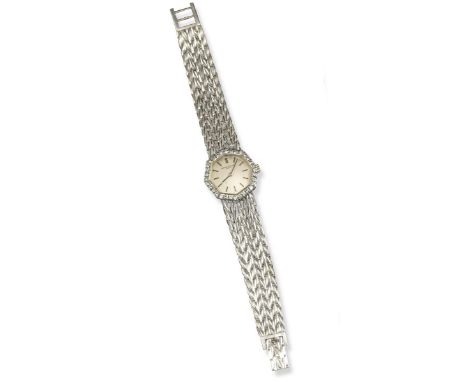 A lady's diamond-set gold wristwatch by Vacheron Constantin, the cream dial with baton numerals, the bezel set with circular-