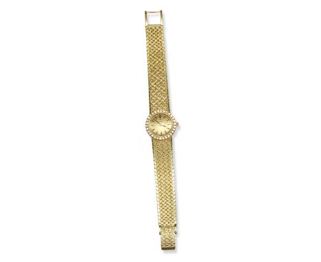 A lady's 18ct yellow gold wristwatch by Omega, the signed circular dial with diamond-set bezel and textured 18ct integrated y