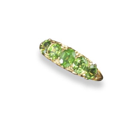 A demantoid garnet five stone ring, the graduated garnets are set in carved and pierced yellow gold mount. Size Q 1/2.