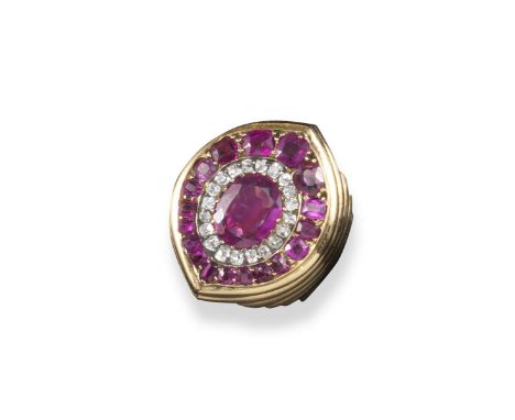 A Burmese ruby and diamond plaque ring, of navette-shaped design and set with a central oval-shaped ruby within a surround of