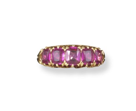 A ruby five stone ring, the graduated oval-shaped rubies are set in yellow gold. Size N.