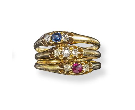 A gem-set triple ring, each section centred with a ruby, diamond and sapphire set with two smaller shoulder diamonds in gold.