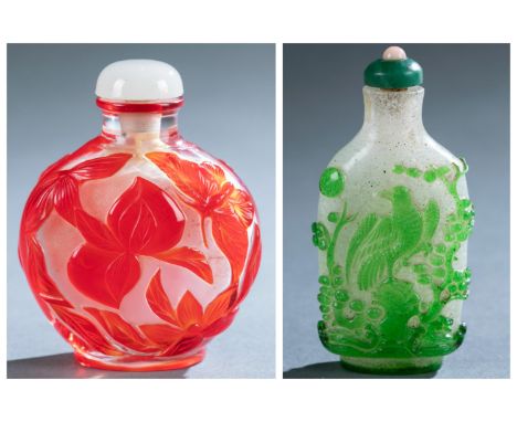 A group of two glass overlay snuff bottles. Late 19th/ early 20th century. ++ Red on clear glass snuff bottle with one face d