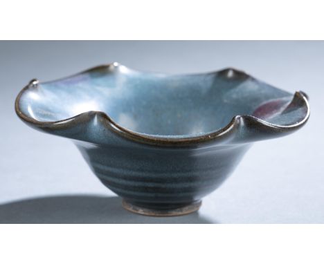 A small Chinese Junyao (Jun Yao) ceramic bowl. Scalloped rim blue blue glaze and purple splash on footed base. 2 1/4" x 5 5/8