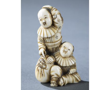 An ivory netsuke of two boys playing with a Daruma doll. 19th century. Unsigned. H: 5.4cmCondition: Chip in back of sitting b