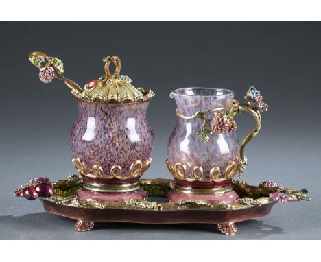 A three piece Jay Strongwater serving set decorated with enamel and rhinestones. Marked on base. Comes with boxes. ++Sugar ja
