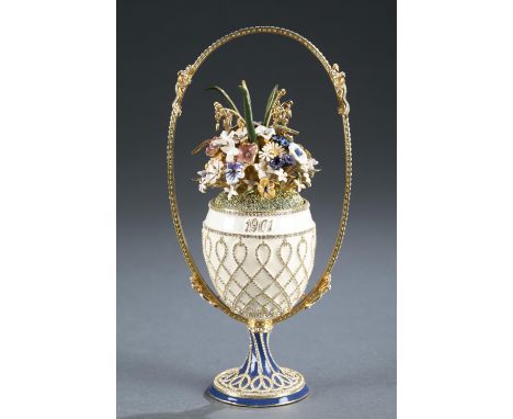A reproduction of Faberge's 1901 "Basket of Flowers" egg. Enamel decorated with rhinestones and gilt trim. Presentation boxes