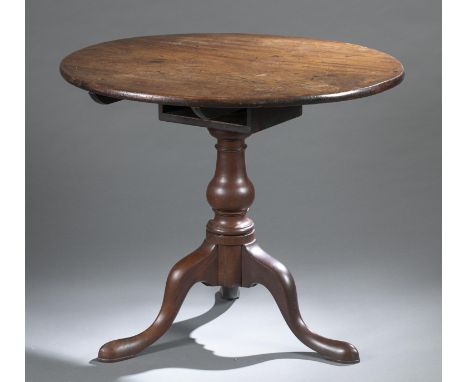 A Chippendale style tilt top table. Circa 19th/20th century. American. Round table top over birdcage, turned standard on trip