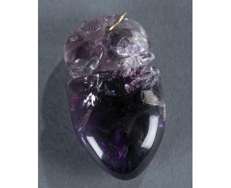 A small carved Chinese amethyst pendants. Tear drop shaped with carved fu lion on top. 1 3/8" x 1 1/8" x 1/2".