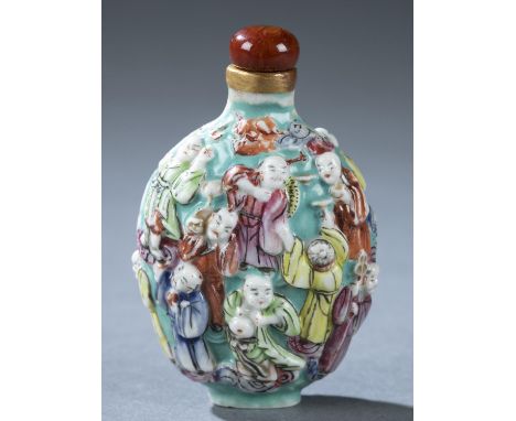 A Chinese molded porcelain snuff bottle. c.1800-1880. Depicting the eighteen Iohans in polychrome enamel on green ground. Fla