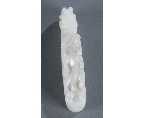 A Chinese white jade belt hook. Carved jade depicting a chilong and a dragon head. 3 1/2" x 3/4" x 7/8".