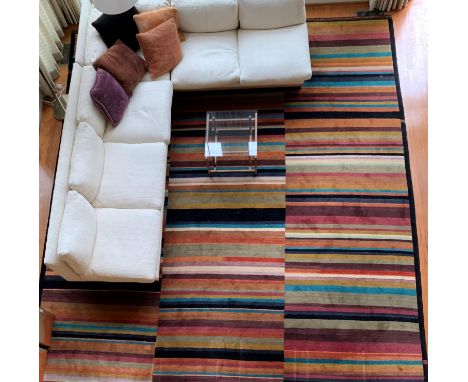 An Odegard Modern Tibetan carpet. Hand woven knotted wool. Three rows of multi-colored stripes. Tag on back corner. 15' x 15'